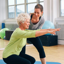 old woman having her physical therapy with the help of therapist