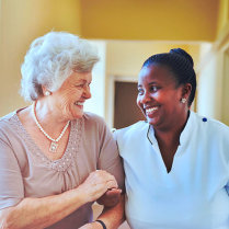 caregiver and old woman smiling