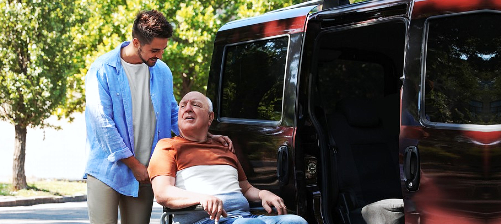 caregiver and old man beside the car