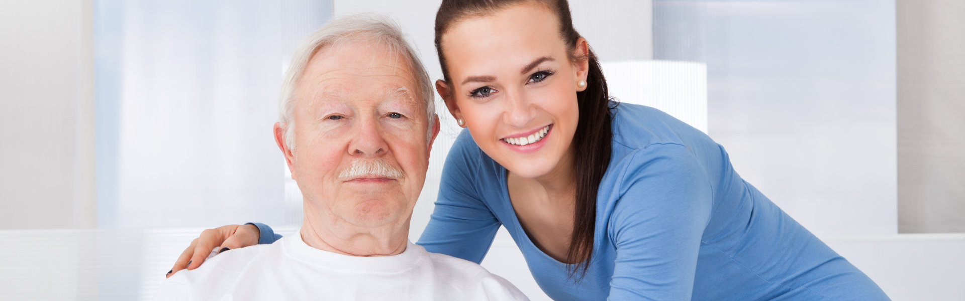 old man and caregiver smiling