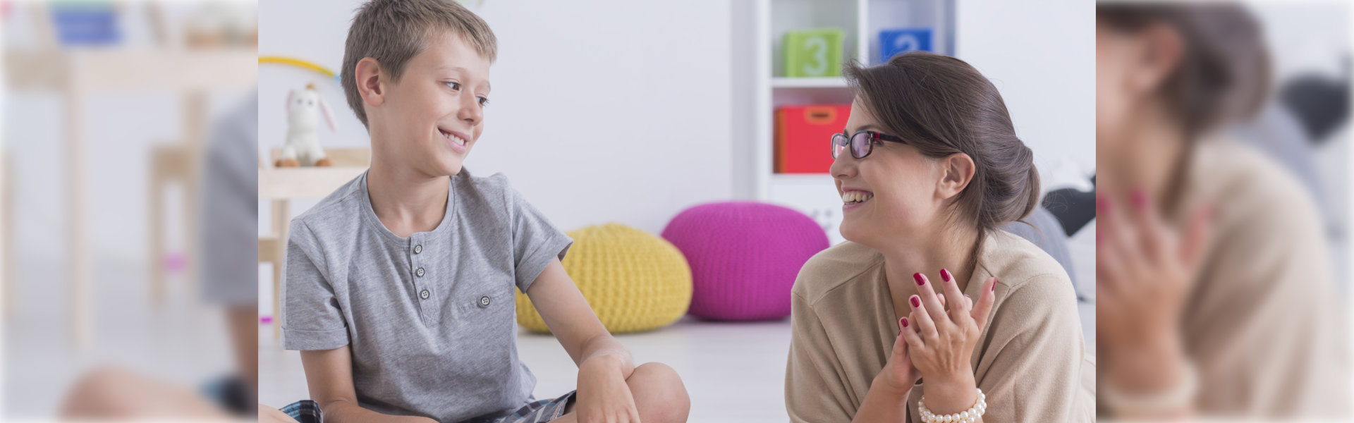Happy little child during during therapy with school counselor